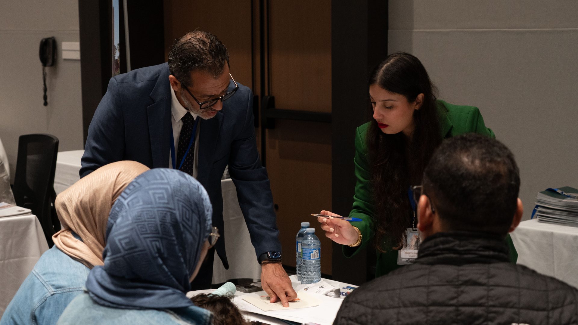 A Chaabi Lil Iskane advisor with visitors, 2025 salon